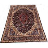 Persian Meshed blue ground carpet, with medallion and interlaced trailing foliate on blue field,