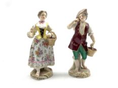 Pair of 19th Century Paris porcelain male and female figures holding baskets on circular gilt bases