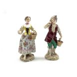 Pair of 19th Century Paris porcelain male and female figures holding baskets on circular gilt bases