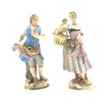 Pair of late 19th Century Meissen country figures of a fruit seller with apples in his apron,