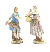 Pair of late 19th Century Meissen country figures of a fruit seller with apples in his apron,