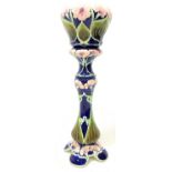 Pottery jardiniere and stand decorated with a raised pattern of flowers on a dark blue ground H93cm