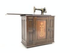 Early 20th century Bradbury's treadle sewing machine, in walnut arts and crafts inlaid case,