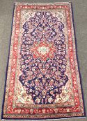 Persian Kashan ground rug, floral medallion on blue field with all over trailing foliate,