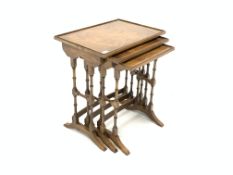 Reprodux walnut nest of three tables, each with raised top,