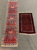 Persian design baluch red ground rug, with repeating octagonal design on orange field,