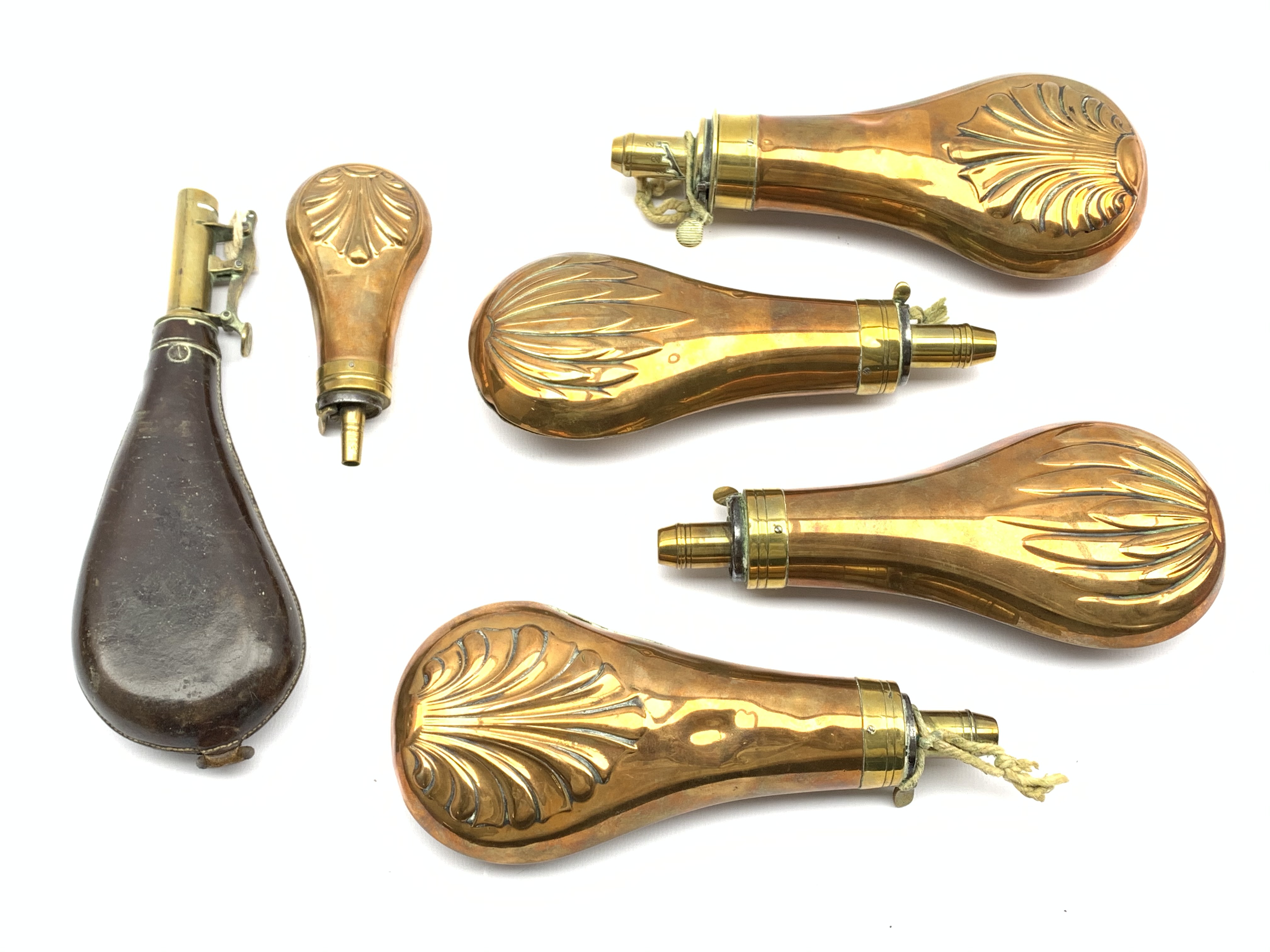 Two 19th Century brass and copper powder flasks by James Dixon Sheffield with shell moulded