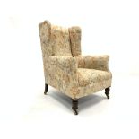 19th century Georgian design wing back armchair, upholstered in cream floral fabric,