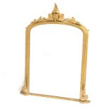 Late 19th century gilt framed upright over mantel mirror, with floral carved applied decoration,