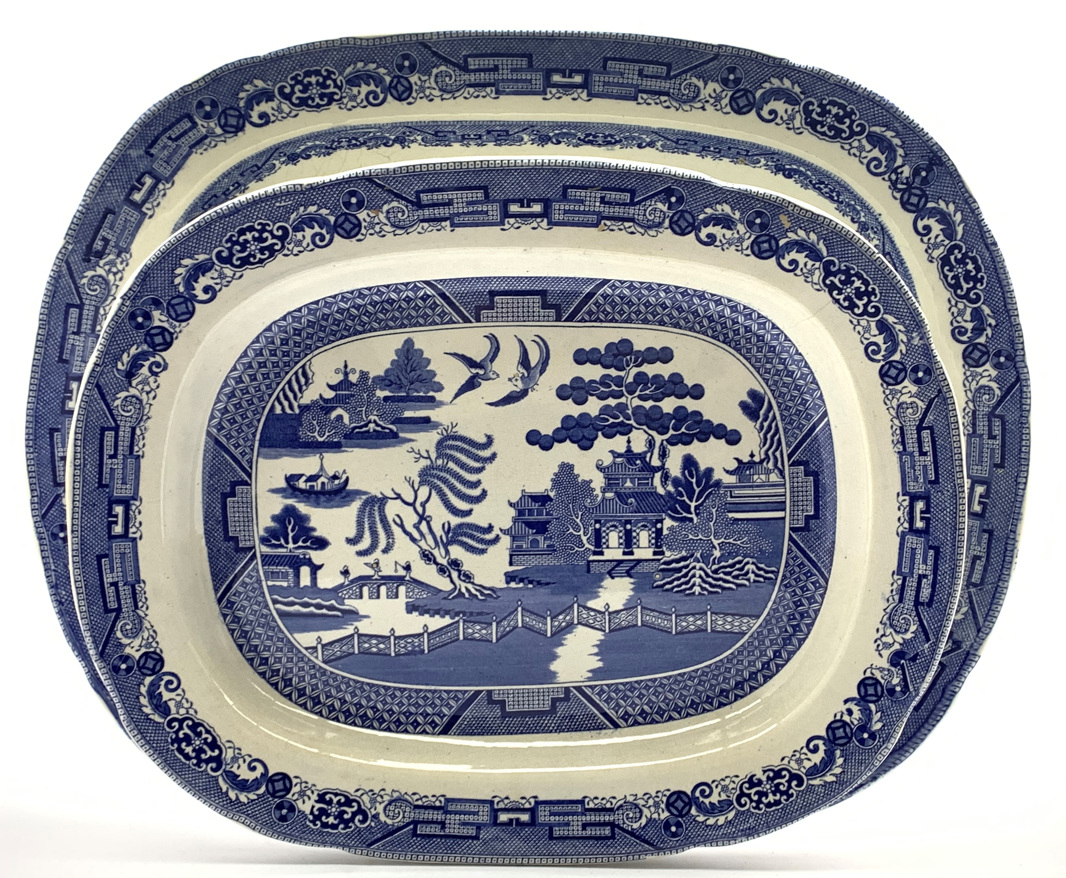 Two large blue and white Victorian earthenware meat plated decorated in the willow pattern,