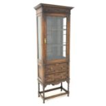 Early 20th century oak bookcase, projecting cornice over floral carved frieze,