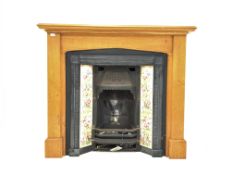 20th century cast iron fireplace with floral tile inserts, in oak surround,