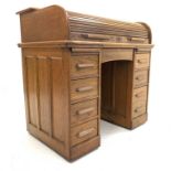 Early 20th century twin pedestal roll top desk, tambour front enclosing drawers,