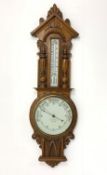 Early 20th century carved oak cased with mercury thermometer on white enamel register,