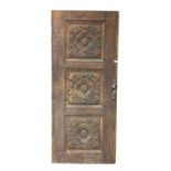 19th century oak exterior door, with three panels with floral rosette decoration carved in relief,