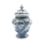 Delft baluster vase and cover decorated with panels of birds and flowers in blue and white H33cm