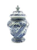 Delft baluster vase and cover decorated with panels of birds and flowers in blue and white H33cm