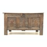 Late 17th century oak coffer, with panelled lid above lunette carved frieze and front panels,