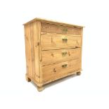 20th century varnished pine chest of four long graduating drawers, on turned bun feet,