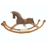 20th century carved pine rocking horse, with leather saddle and stirrups,
