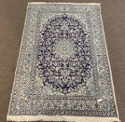 Persian design ivory ground rug, central medallion and trailing foliate on blue field,