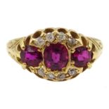 Victorian gold three stone ruby, with diamond surround ring,