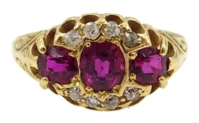 Victorian gold three stone ruby, with diamond surround ring,