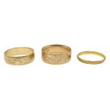 22ct gold band and two 9ct gold band engraved decoration,