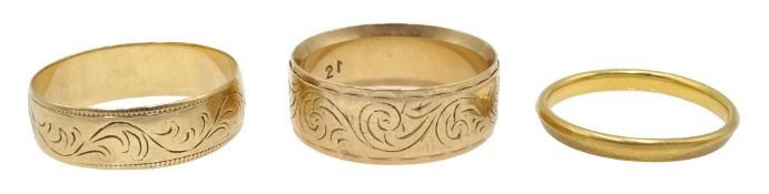 22ct gold band and two 9ct gold band engraved decoration,