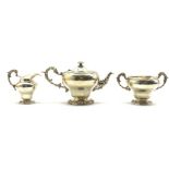 Late Victorian silver 3 piece circular tea set with embossed floral decoration,