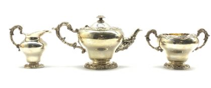 Late Victorian silver 3 piece circular tea set with embossed floral decoration,