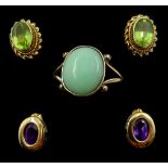 Gold cabochon jade ring, pair of gold peridot stud earrings and pair of gold amethyst stud earrings,