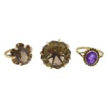 Two gold quartz rings and an amethyst ring,