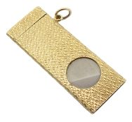 9ct gold and stainless steel rectangular cigar cutter with engine turned decoration and hanging