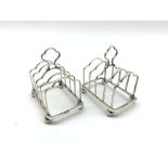 Pair of small silver four division toast racks with loop handles and ball feet L5.