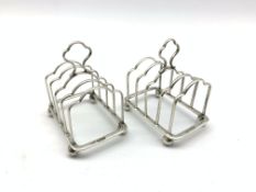 Pair of small silver four division toast racks with loop handles and ball feet L5.