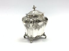 Edwardian silver tea caddy of bombe form with embossed decoration on scroll feet H15cm Sheffield