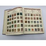 'The Empire Postage Stamp Album' containing Queen Victoria and later Great British and World stamps