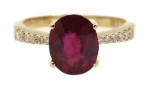 18ct gold oval ruby ring with diamond shoulders,