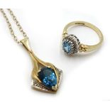 Gold blue topaz and diamond pendant necklace and oval blue topaz and diamond ring,