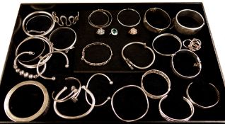 Three stone set contemporary silver rings and thirteen silver bangles all hallmarked or stamped and