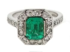 18ct white gold emerald and diamond cluster ring, with diamond set shoulders,
