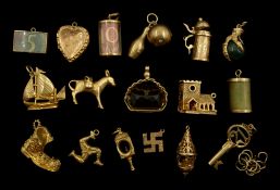9ct gold charms including boat, boot, blood stone eagle claw and church, 18ct gold donkey charm,