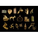 9ct gold charms including boat, boot, blood stone eagle claw and church, 18ct gold donkey charm,