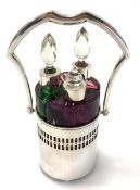 Three Gablonz Bohemian 800 silver mounted coloured glass scent flasks in silver frame with swing
