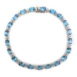 18ct white gold oval blue topaz and diamond bracelet, stamped 750, topaz total weight 12.