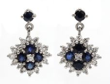 Pair of 18ct white gold diamond and sapphire cluster pendant earrings,