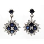 Pair of 18ct white gold diamond and sapphire cluster pendant earrings,