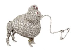 Platinum poodle brooch pave set diamonds, cabochon ruby eyes and calibre cut ruby bow, stamped P.