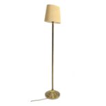 Early 20th century brass standard lamp having spiral column, stepped round base and shade,